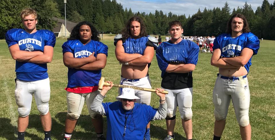 Coach Jay Freeman with five Curtis Vikings linemen — Ludus Award winner